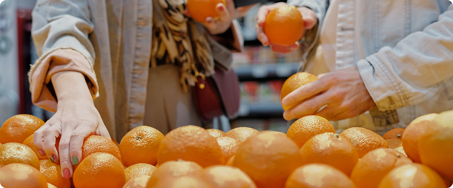 Hands sorting fresh oranges